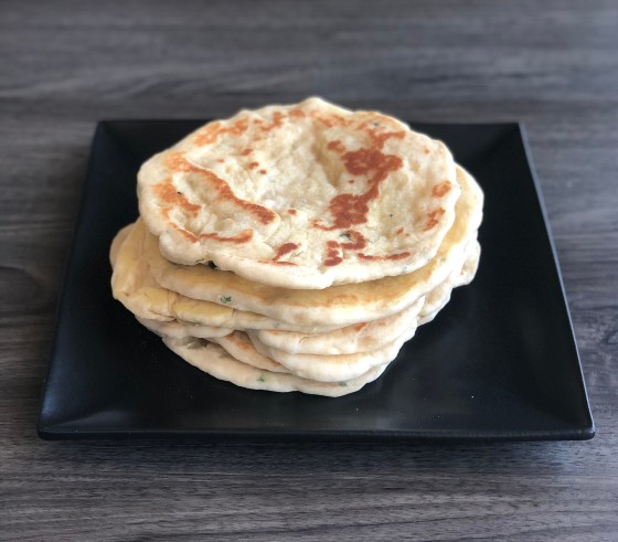 A stack of a soft Turkish Flatbread on top of other flatbreads